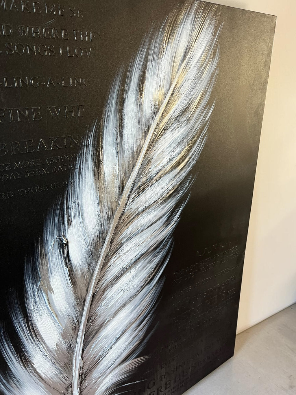 Painting featuring text and a giant feather